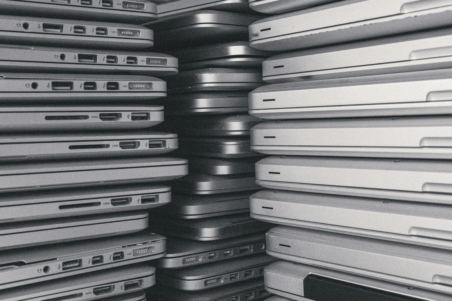Retired laptops stacked for processing